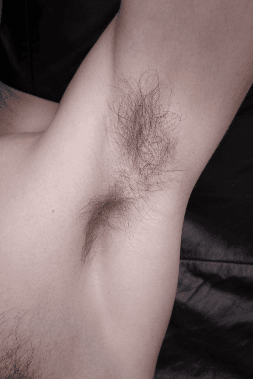 Hairy armpit in leather couch 